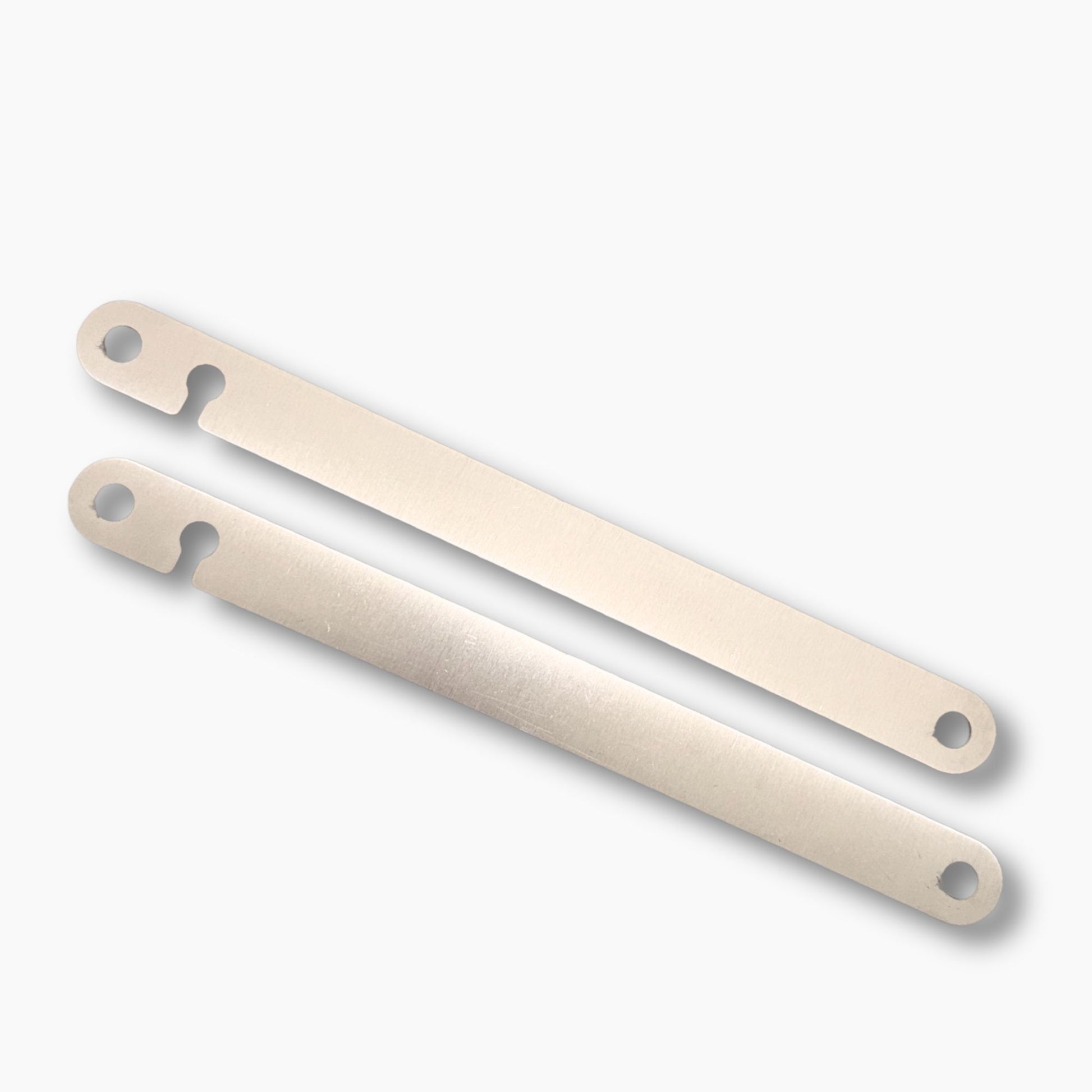 Two dyna strut filler plates with holes on a white background